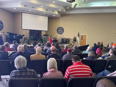 A seated congregation facing a platform