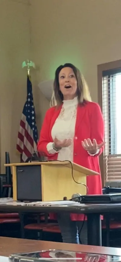 Christine Leeviraphan speaking beside a lectern